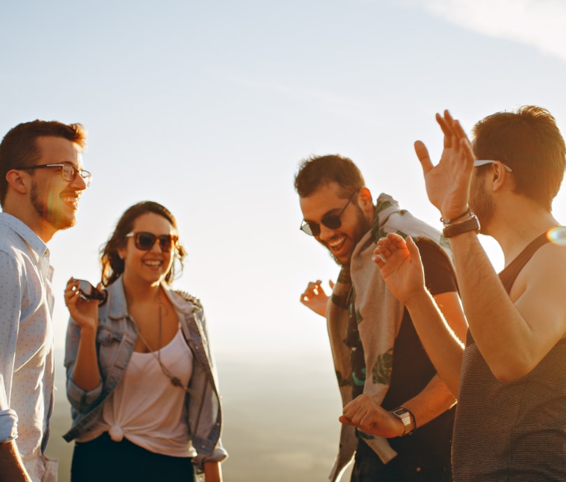 group of friends during golden hour smiling