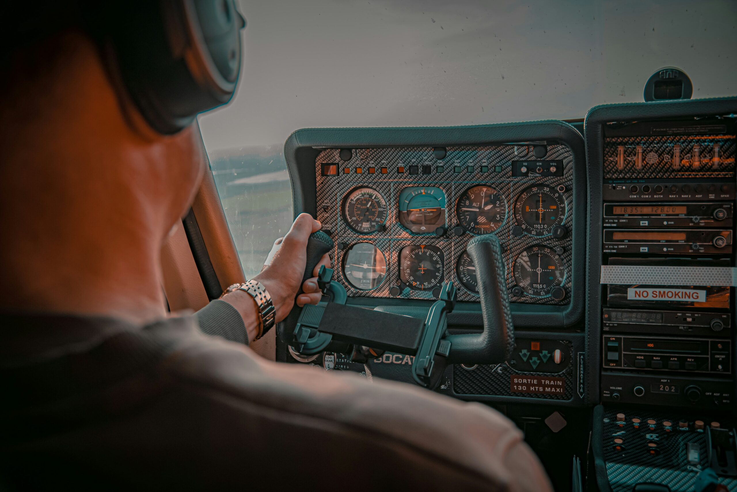 pilot in cockpit flying aircraft